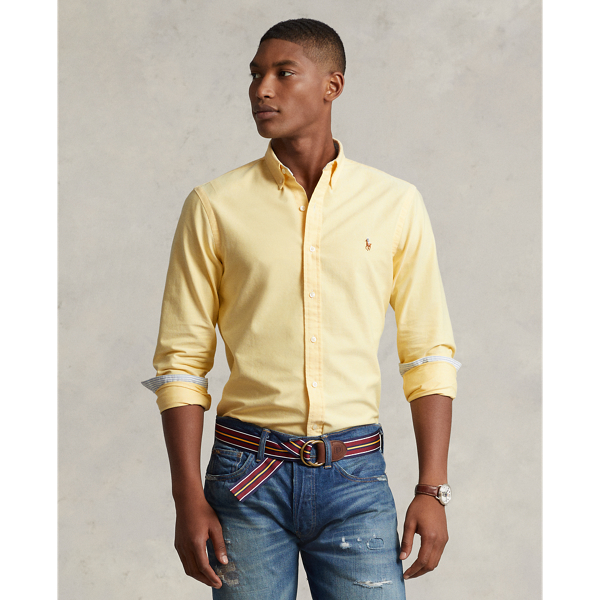 The oxford shirt made its debut very early in  Ralph Lauren Lauren’s designs, and since then, it has solidified its status as a pillar of the Polo look. Our fabric is developed with a secret wash, giving it instant character, ease and a heathered softness – what we refer to as "the perfect rumple". The formula is so unique that it's been kept in a safe for more than three decades. Today, Mr Lauren continues to create countless variations of his iconic shirt, including this Custom Fit version, which is embroidered with our multicoloured signature Pony.