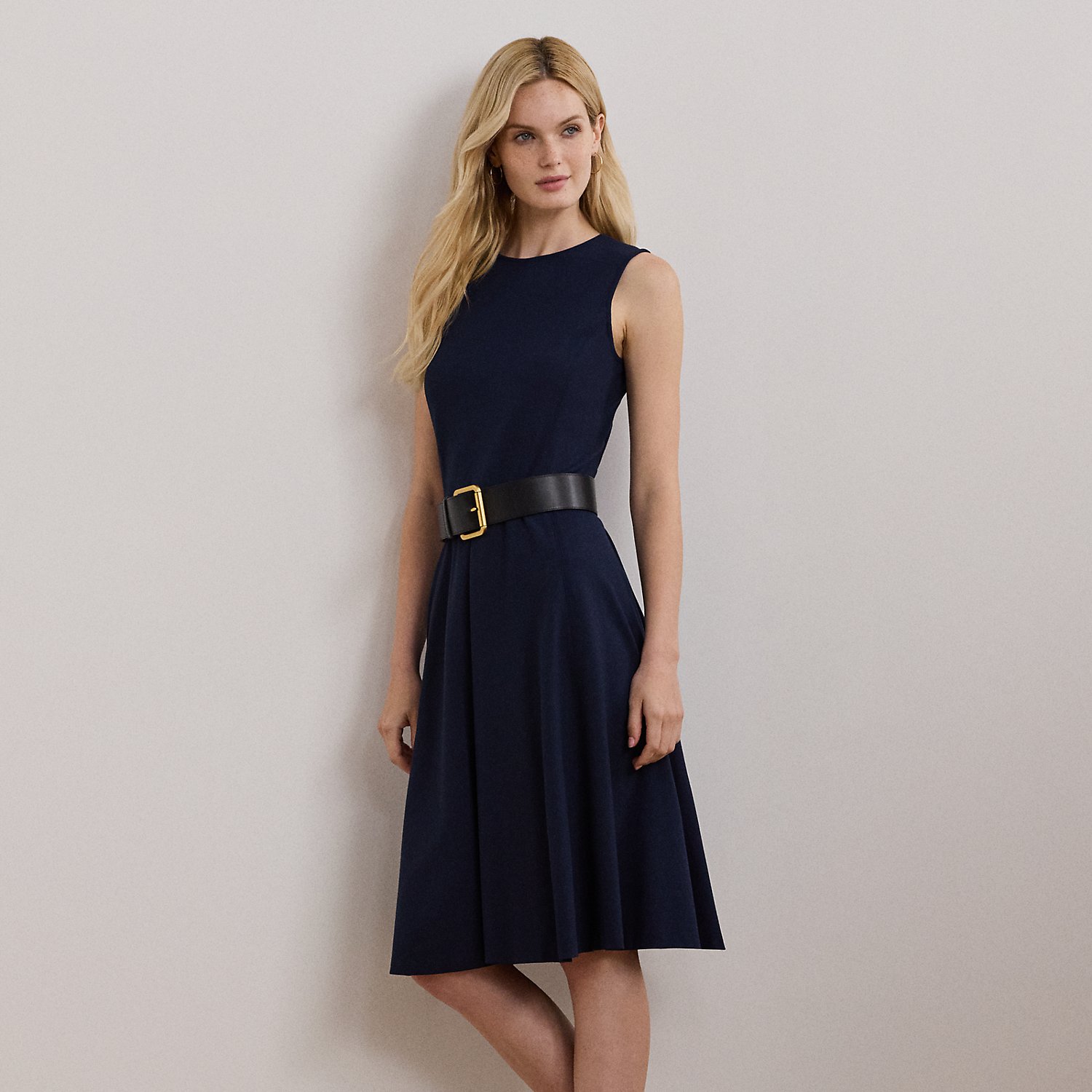 This sleeveless dress is designed with body-shaping princess seams and is crafted with smooth ponte, amplifying its feminine fit-and-flare silhouette.