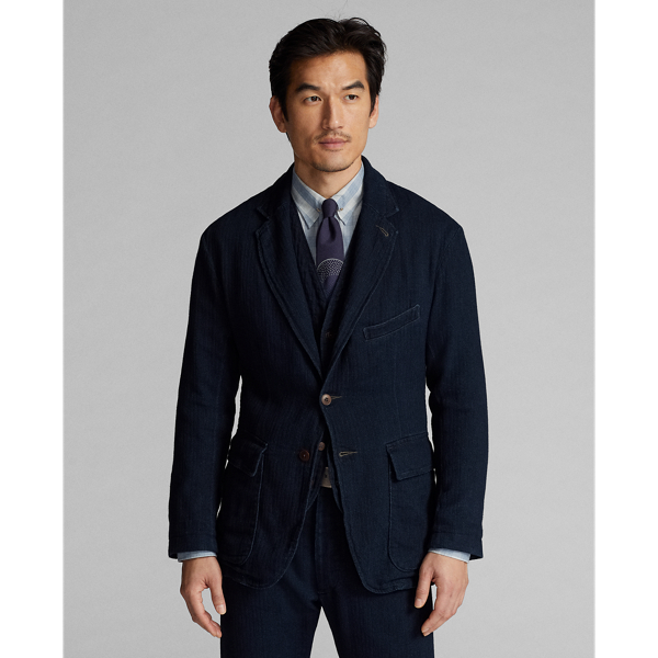 Made with Japanese cotton herringbone that is yarn-dyed with indigo. Half-lined. Corozo buttons.