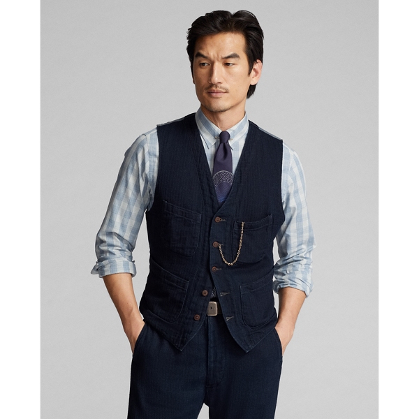 Made with Japanese cotton herringbone that is yarn-dyed with indigo. Adjustable buckled back. Fully lined. Corozo buttons.