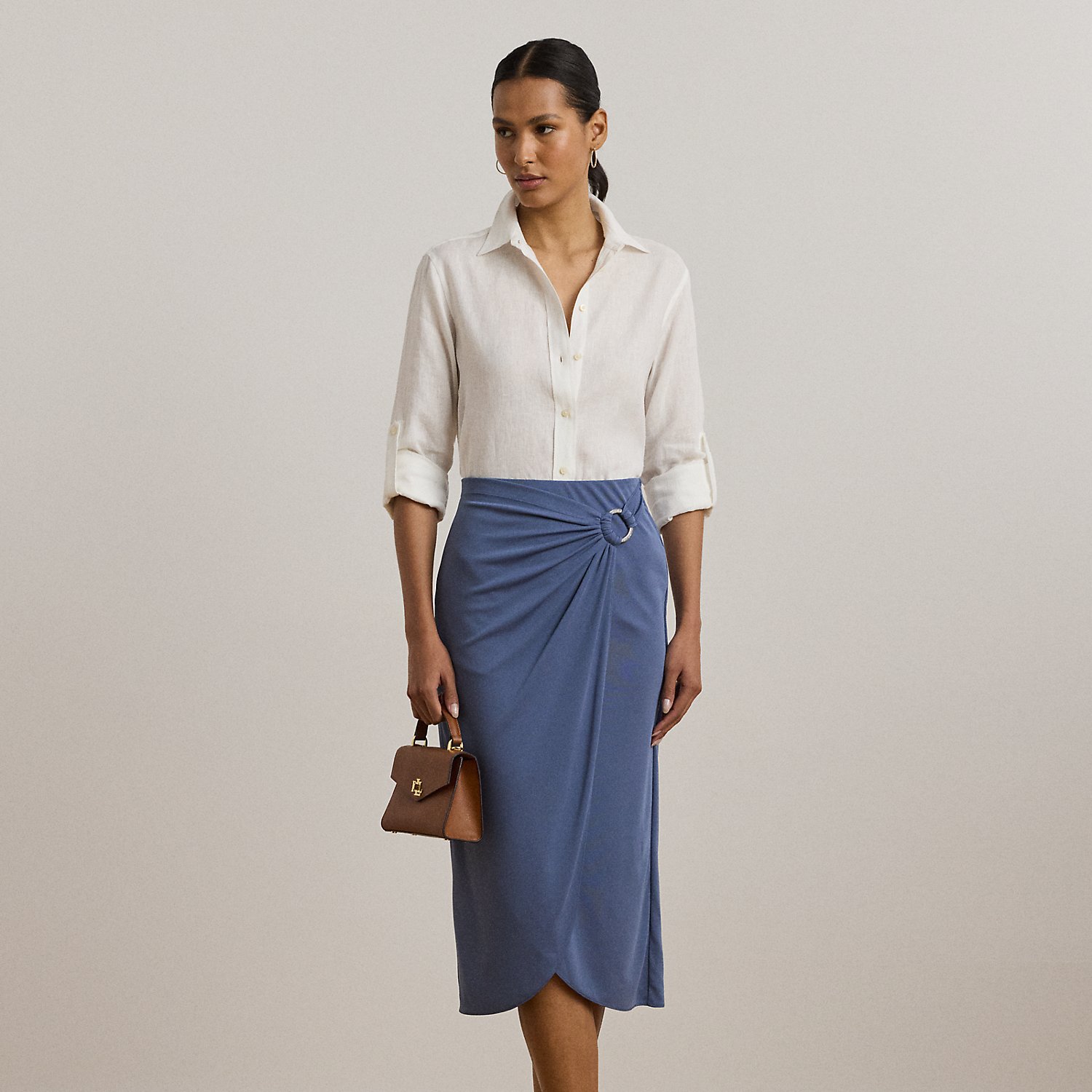 Crafted with soft stretch jersey, this midi-length pencil skirt features a pleated wrap-style overlay that gathers into an "LRL Lauren Ralph Lauren Lauren"-engraved metal O-ring at the waist.