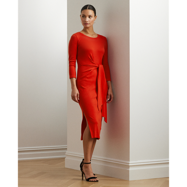 Rib-knit with a soft stretch-cotton blend, this long-sleeve crewneck dress is cut for a slim-fitting silhouette and a calf-grazing midi length. A tie-front design at the waist adds contemporary flare, while a skirt slit affords ease of movement.