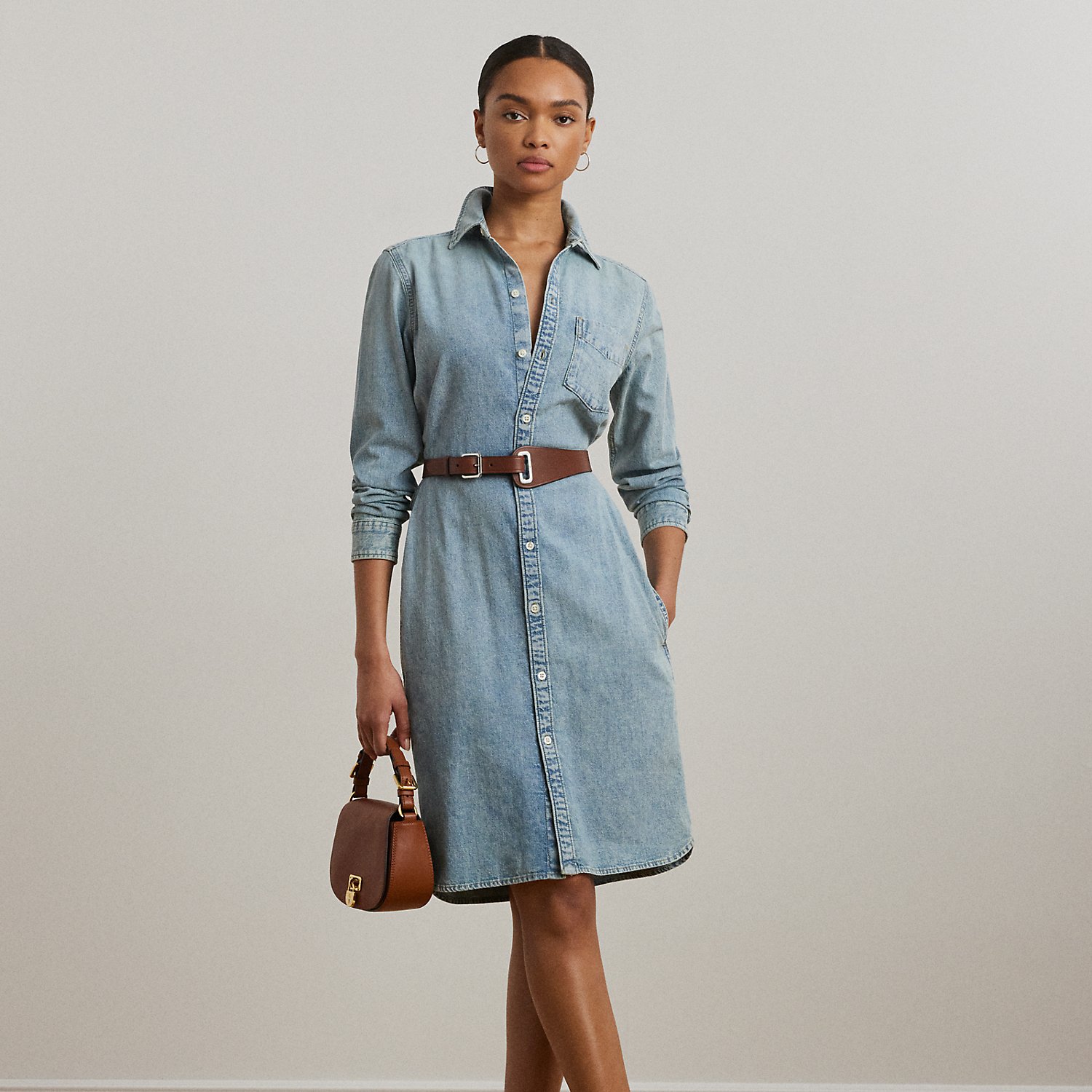 Tailored from light-wash right-hand-twill denim, this version of Lauren Ralph Lauren Lauren's signature belted shirtdress strikes the perfect balance between effortless and sophisticated.