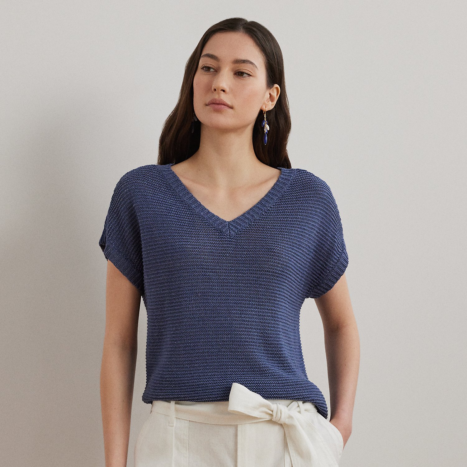 Cut for a relaxed-fitting silhouette, which tapers slightly at the hip, this V-neck jumper's short-sleeve design and lightweight linen-blend fabrication make it a perfect piece for transitional dressing.