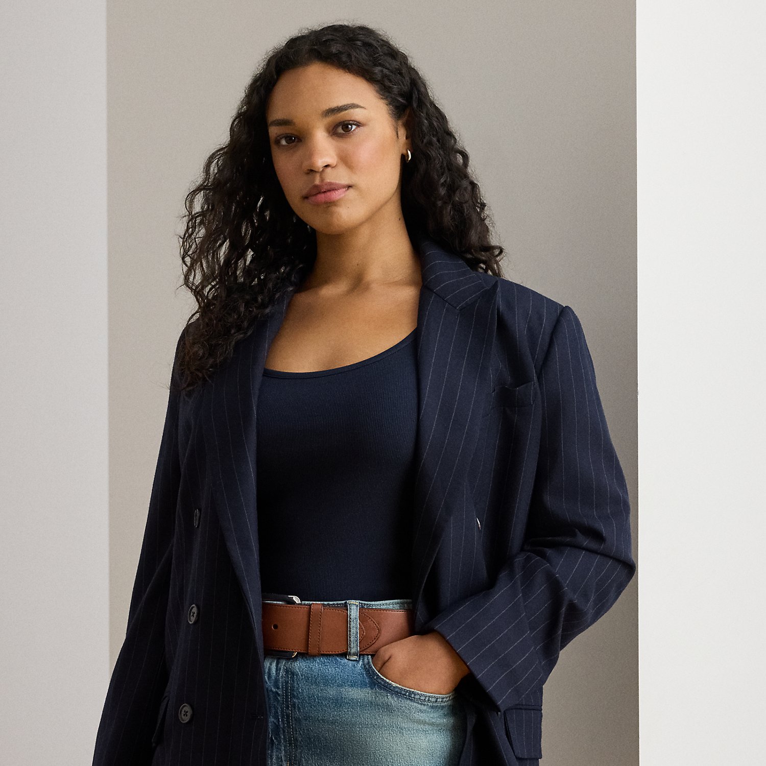 Slender, yarn-dyed pinstripes punctuate the structured silhouette of this sophisticated double-breasted blazer, which is finished with peak lapels and signature horn-effect buttons.