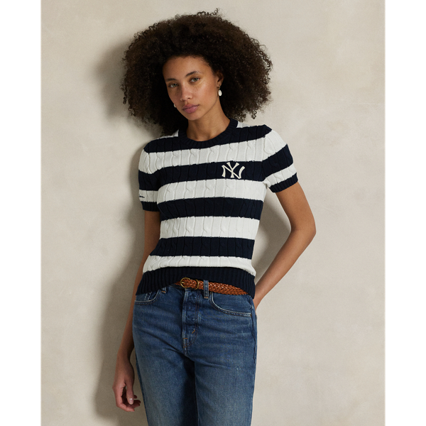 As a boy growing up in the Bronx, Mr Lauren loved going to Yankee Stadium™ to watch his hometown heroes play ball. This cable-knit cotton jumper celebrates Mr Lauren's long-standing love of the Bronx Bombers™ and the game of baseball with a felt patch of the New York Yankees™ logo.