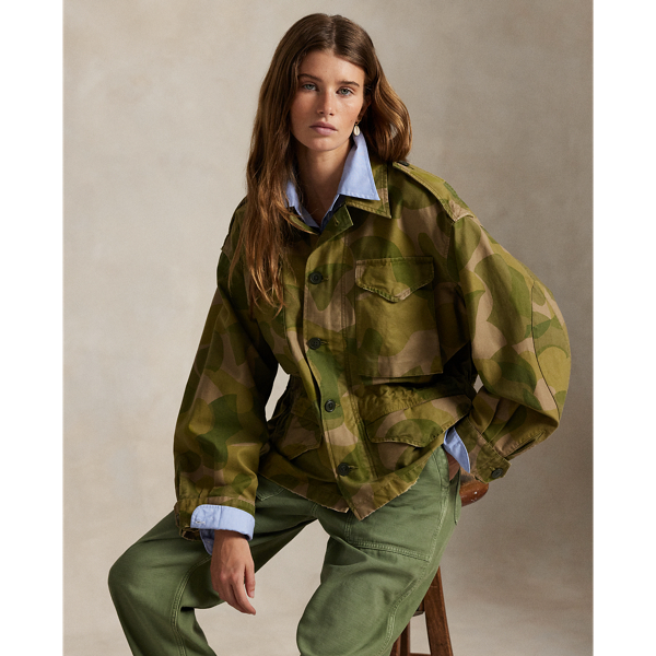 Printed for a surplus-inspired motif, this cotton field jacket balances a cropped silhouette with traditional details, including a buttoned storm placket over a concealed zip closure, shoulder epaulets and patch pockets. The authentic bi-swing construction features a drawstring waist and raw hem.