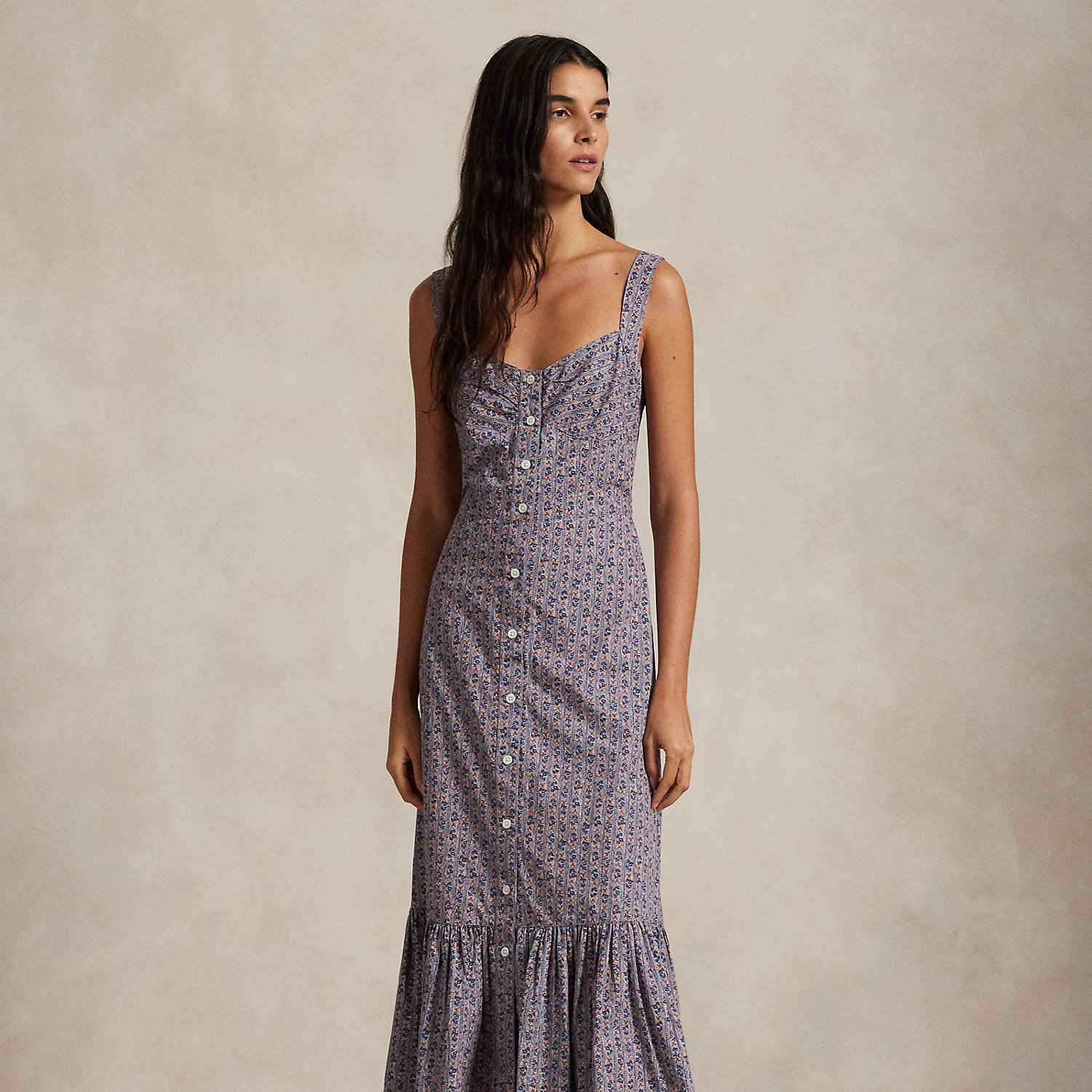 This quintessential warm-weather dress is crafted with floral-print cotton and features a front placket with genuine mother-of-pearl buttons. The fitted bodice and tiered hem create a classic A-line silhouette.