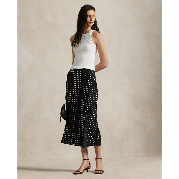 Printed with an all-over polka-dot motif, this satin skirt is cut on the bias for a slightly flared hem, bringing fluid movement to each step.