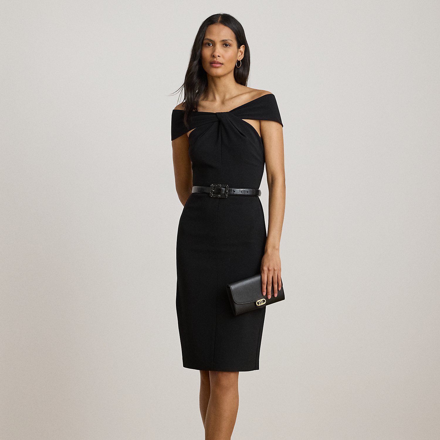 Distinguished by a twist-front off-the-shoulder neckline, this refined cocktail dress features a sheath silhouette crafted from smooth, stretch-infused crepe.