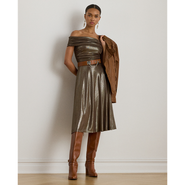 This cocktail dress pairs metallic foiled jersey with a ruched off-the-shoulder bodice and a flared skirt, making this style a striking choice for special occasions.