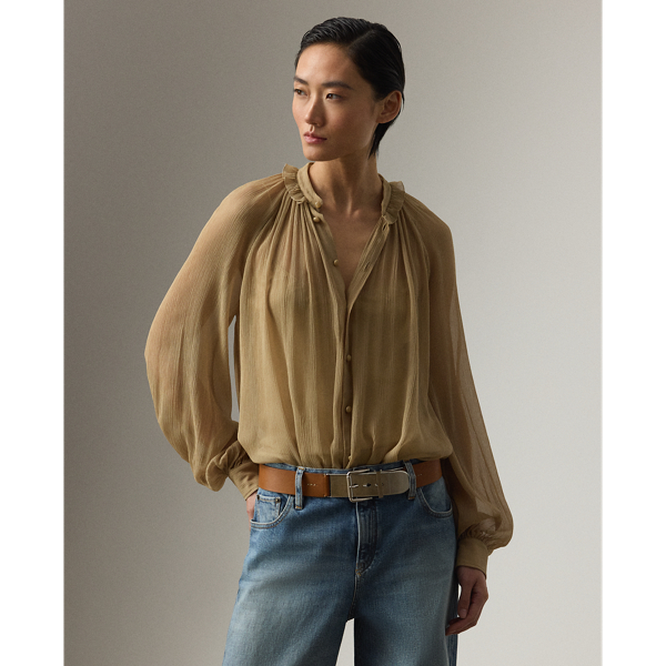 Epitomising the romantic allure that defines  Ralph Lauren Lauren Collection, this blouse is designed with an array of highly considered elements, including delicate shirring, billowing blouson sleeves and ruffle trim along the band collar. Effortlessly elegant, the Brooklyn is crafted in Italy from 100% silk chiffon woven with a crinkle texture, providing depth and dimension while remaining sheer and breezy.