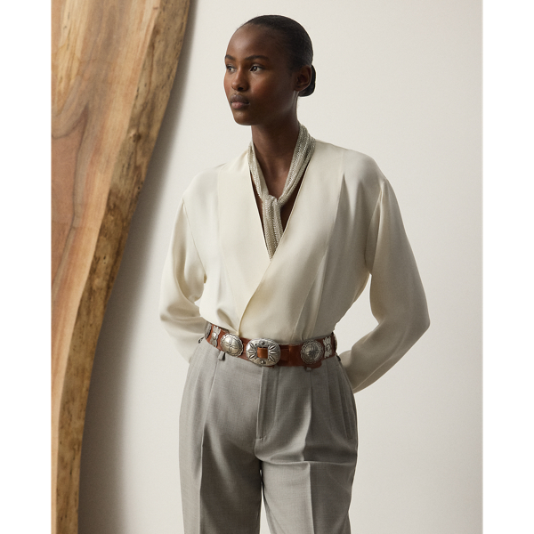 A representation of the romantic, timeless style that defines  Ralph Lauren Lauren Collection, the Liora blouse is designed with a sleek, figure-flattering wrap silhouette, which easily secures with a genuine mother-of-pearl button. Crafted in Italy, this effortless blouse is made with modern silk marocaine for a fluid drape.