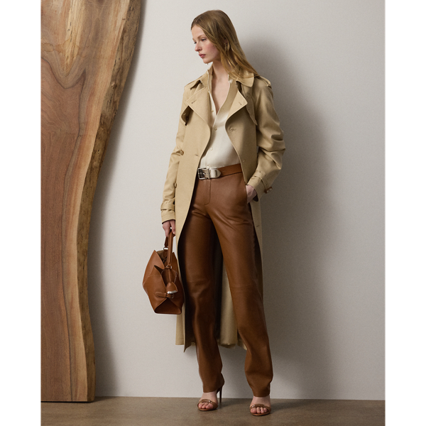 The Italian-made Alecia – realised here using traditional trench coat details, including buttoned shoulder epaulettes, storm flaps, a belted collar and waist and a double-breasted silhouette – is made from a silk-and-cotton fabric for a luxuriously soft and rich hand feel. Genuine horn buttons, lambskin-covered buckles and a calf-grazing length add refinement to its timeless design.
