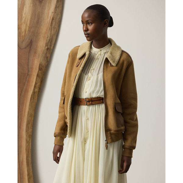 Inspired by traditional flight jackets, the Morrison coat is crafted from a luxurious combination of textures, including soft, ultra-lightweight wool shearling, which displays a semi-curly interior and a smooth suede exterior, and supple lambskin taping for a sophisticated yet dynamic contrast, which enhances the relaxed-fitting design of this coat. Additional details, including a lambskin buckled throatlatch, rib-knit cuffs and hem, and lambskin flapped pockets, complete the look.