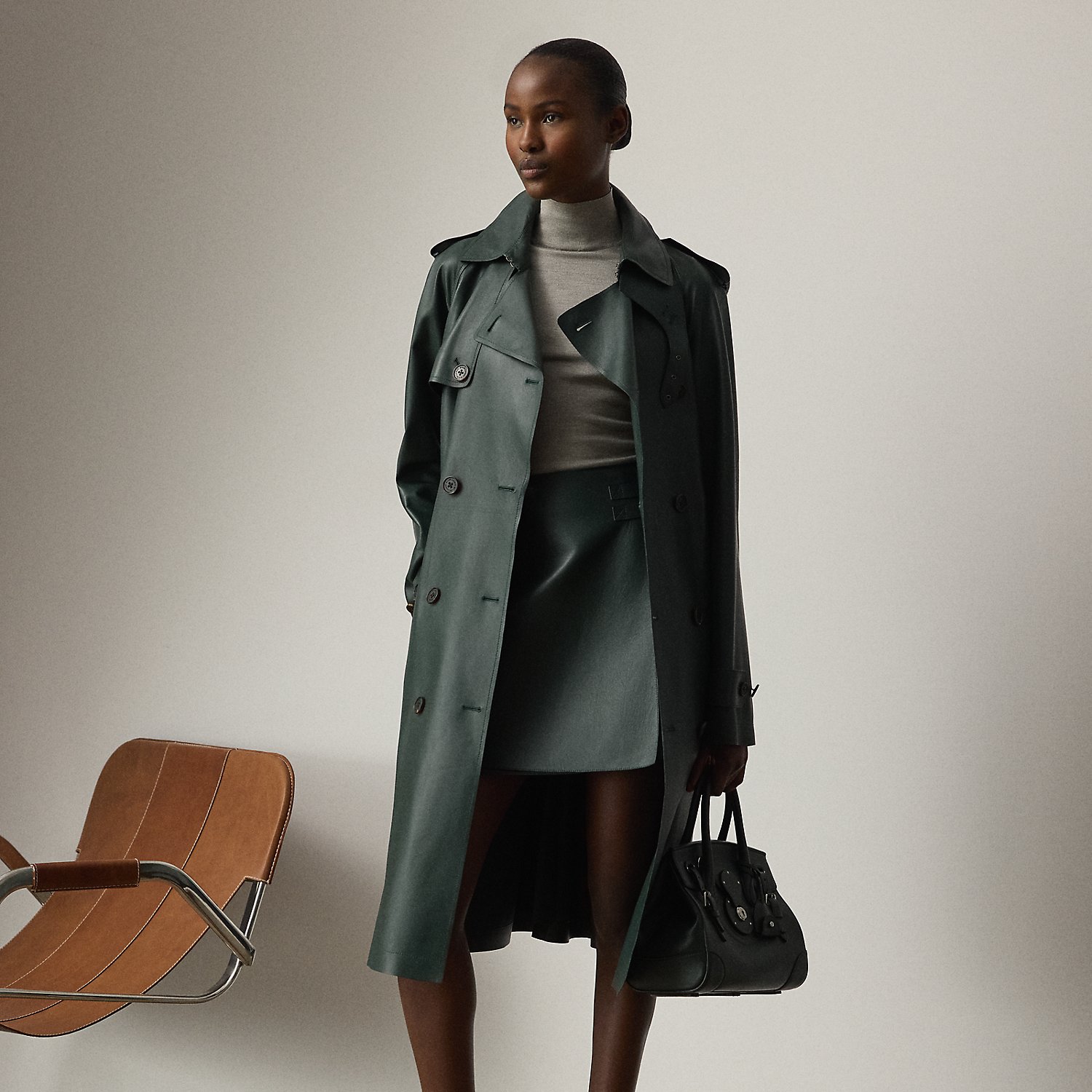 The Italian-made Niles – realised here using traditional trench coat details, including buttoned shoulder epaulets, storm flaps, a belted collar and waist and a double-breasted silhouette – is made with supple nappa lambskin that's specially dyed to the season's dark racing green hue – a colour directly inspired by one of Mr Lauren's iconic vehicles. Imitation horn buttons, lambskin-covered buckles and a debossed logo on the undercollar add refinement to its timeless design.