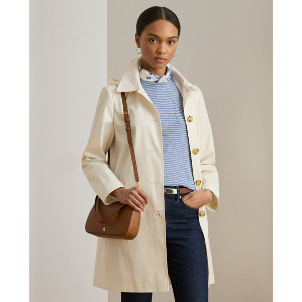 With a water-repellent cotton-blend shell and a menswear-inspired balmacaan coat silhouette, this piece seamlessly merges practical design elements with sophisticated sartorial details. A detachable hood offers versatility, while "Lauren Ralph Lauren Lauren"-engraved horn-effect buttons add a signature finish.