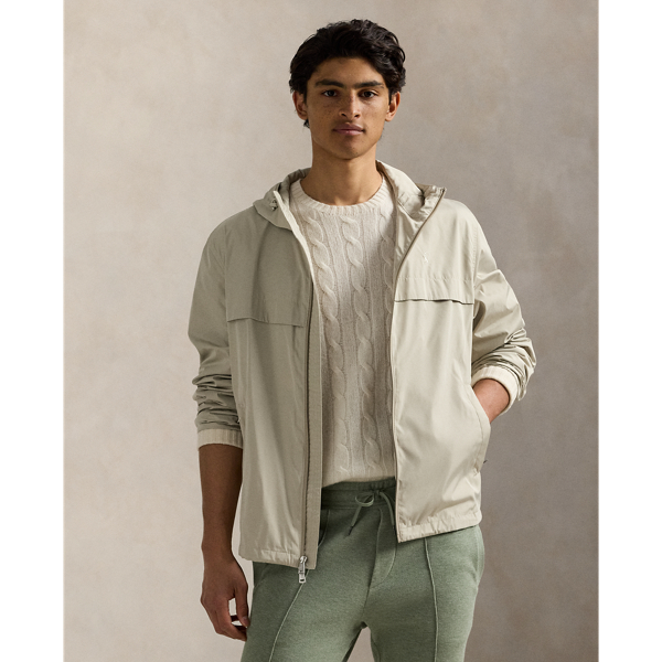Crafted from water-repellent fabric, this jacket features functional details, such as a mesh-lined vented back and metal grommets on the underarms for breathability.