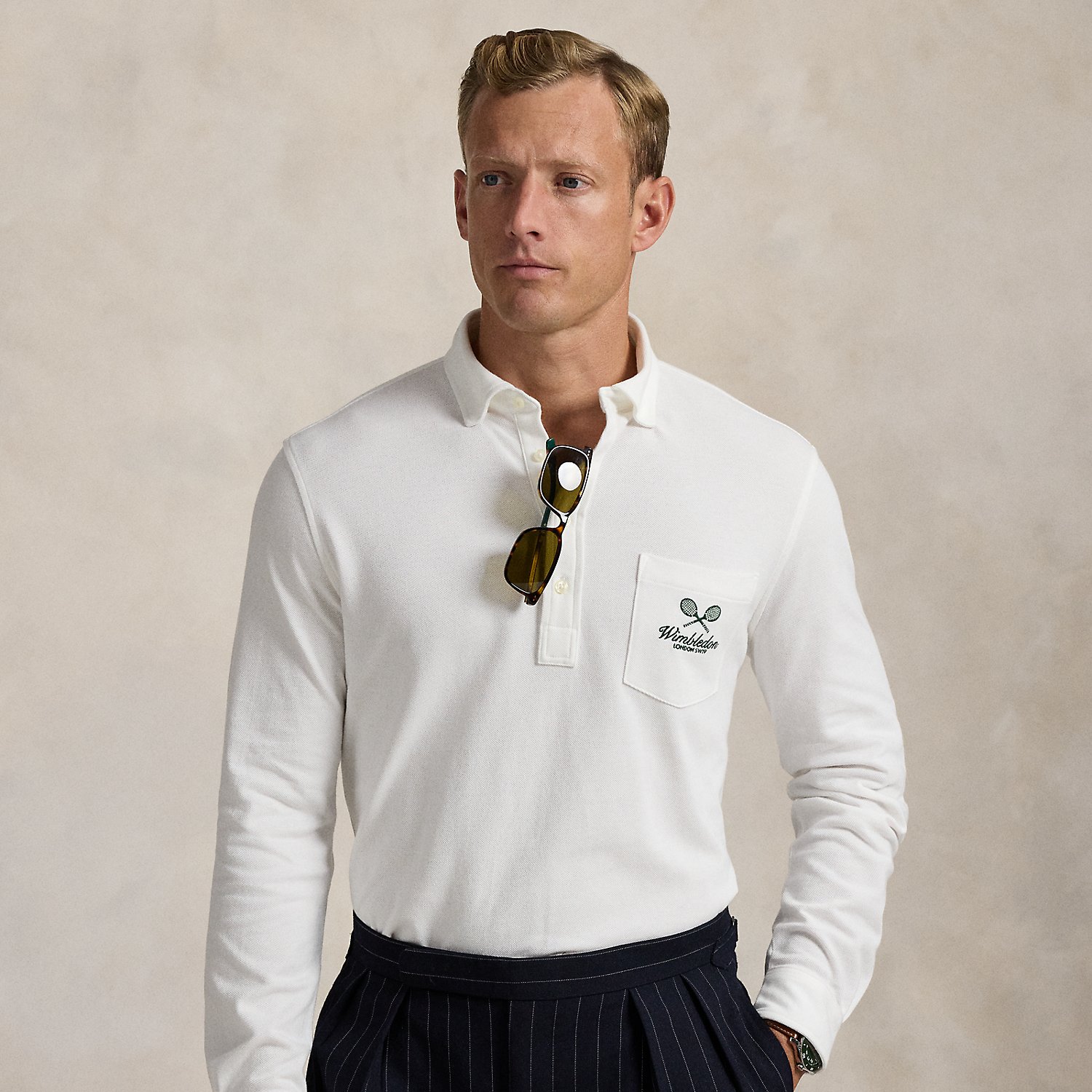 Part of our collection celebrating Wimbledon 2025, this unisex Polo shirt is embroidered with the tournament's logo and location, which includes its "SW19" postcode. Our signature embroidered Pony and genuine mother-of-pearl buttons adorn this cotton mesh style.