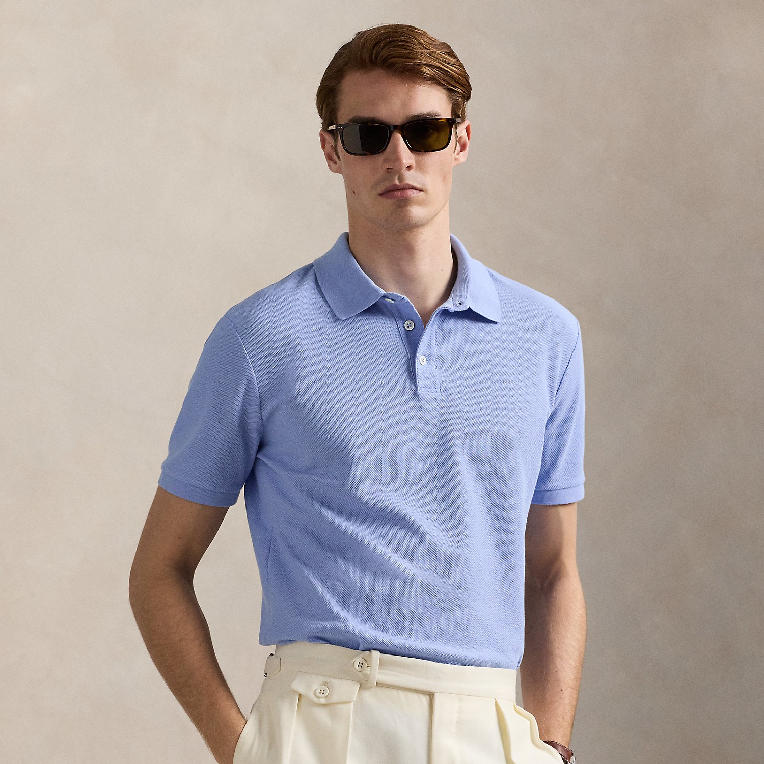 An American style standard since 1972, the Polo shirt has been imitated but never matched. Over the decades, Ralph Lauren Lauren has reimagined his signature style in a wide array of colours and fits, yet all retain the quality and attention to detail of the iconic original. This version is made with honeycomb-textured cotton mesh and finished with genuine mother-of-pearl buttons.