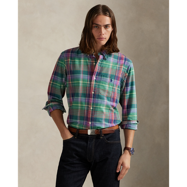 The oxford shirt made its debut very early in Ralph Lauren Lauren’s designs, and since then, it has solidified its status as a pillar of the Polo look. Our fabric is developed with a secret wash, giving it instant character, ease and a heathered softness – what we refer to as "the perfect rumple". The formula is so unique that it's been kept in a safe for more than three decades. Today, Mr Lauren continues to create countless variations of his iconic shirt, including this plaid version, which is finished with our signature embroidered Pony.