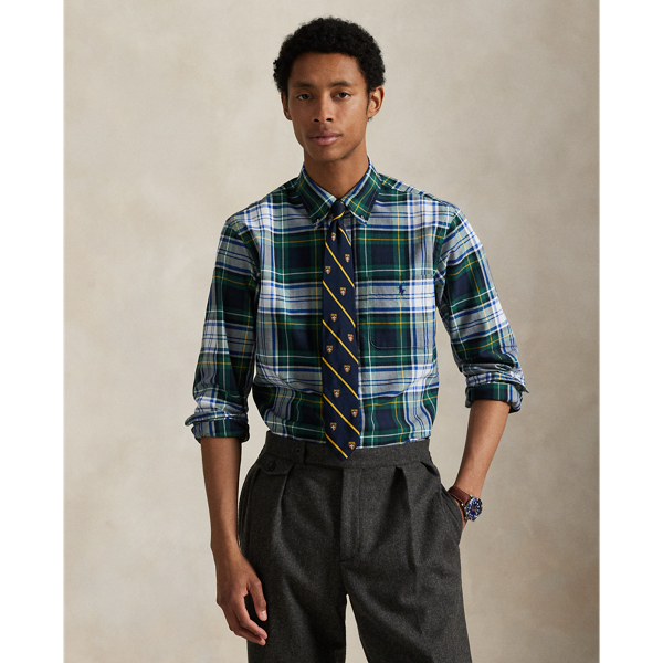 The oxford shirt made its debut very early in Ralph Lauren Lauren’s designs, and since then, it has solidified its status as a pillar of the Polo look. Our fabric is developed with a secret wash, giving it instant character, ease and a heathered softness – what we refer to as "the perfect rumple". The formula is so unique that it's been kept in a safe for more than three decades. Today, Mr Lauren continues to create countless variations of his iconic shirt, including this plaid version, which is finished with our signature embroidered Pony.
