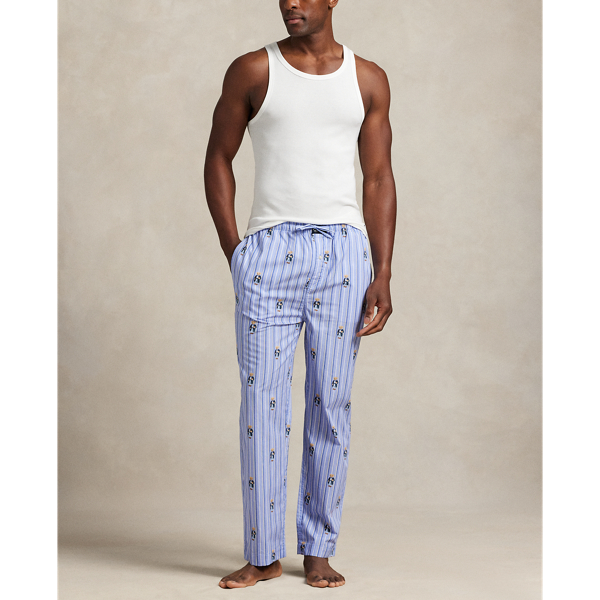 These striped woven cotton pyjama trousers feature an allover pattern of the Polo Bear wearing  Ralph Lauren Lauren's iconic cricket jumper and madras trousers.
