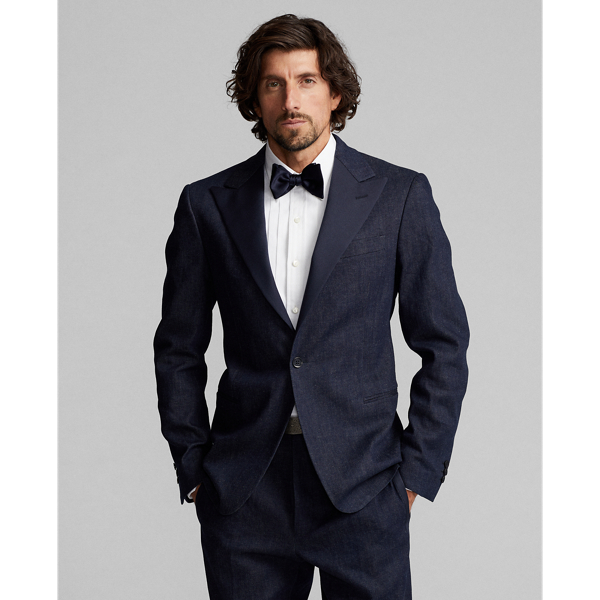 Tuxedo jacket tailored in Italy. Custom-developed Japanese denim woven with a stretch cotton blend featuring linen and ramie. Dyed with indigo. Satin peak lapels. Half-lined.