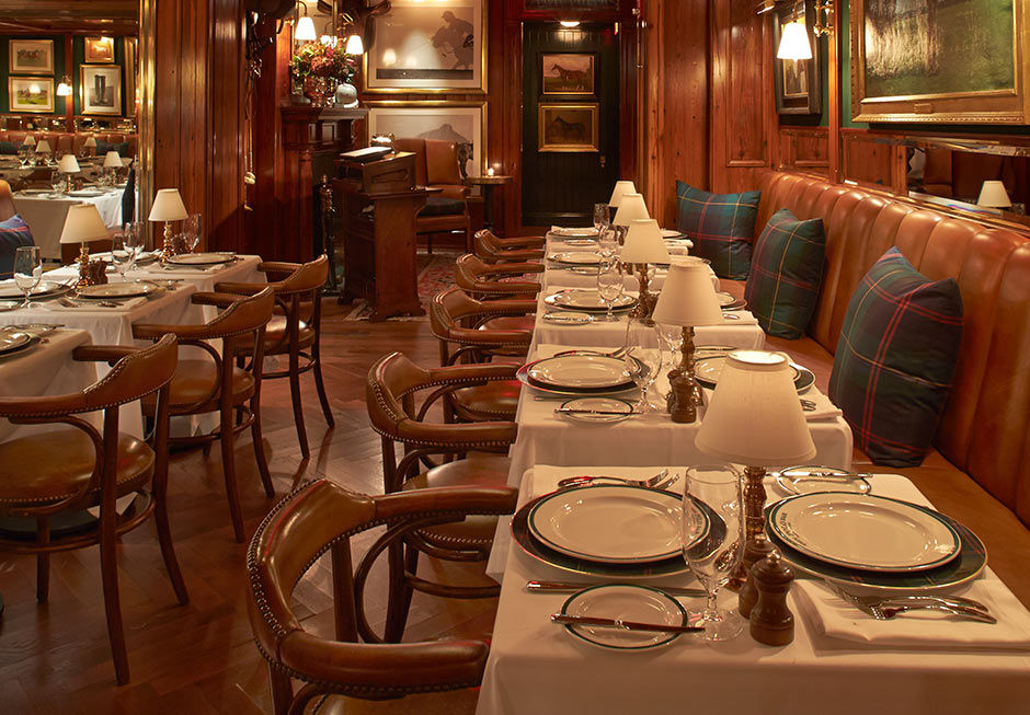 Cozy two-tops with banquette seating and tartan pillows.