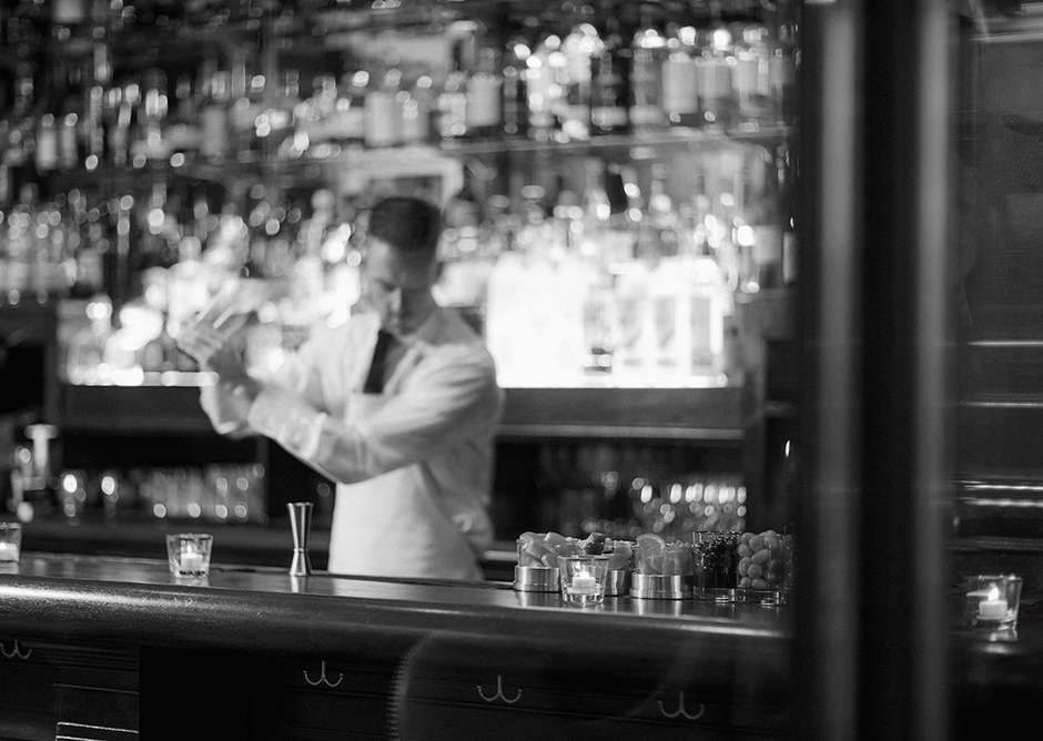 Black & white photograph of bartender preparing cocktail